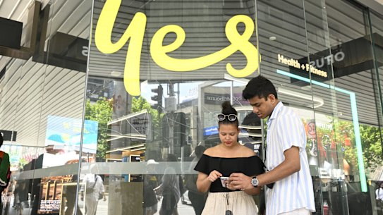 Ranish Kromodoyo and Anya Absalom struggle to make a call outside an Optus store.