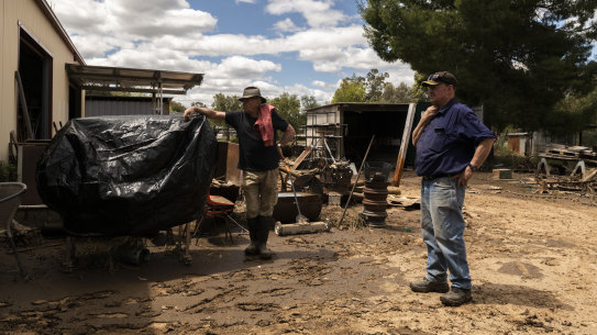 Eugowra locals Jack Barnes and Ron Hay clean up the men’s shed, where they host dozens of older men in town for coffee and conversations to help foster connection. All their equipment was destroyed in the flood.