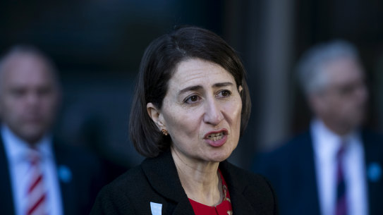 Premier Gladys Berejiklian, flanked by education officials, announces a gradual return to classrooms