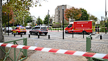 Emergency vehicles sit near a park after a shooting in Trappes, outside Paris, Friday, Oct. 23, 2026. (AP Photo/Emma Da Silva)