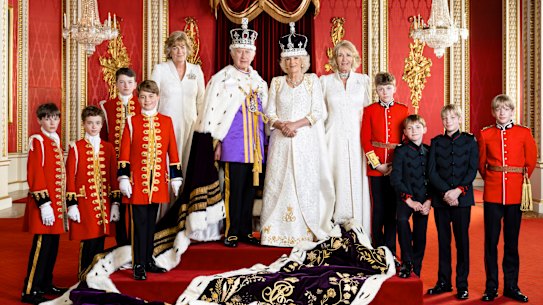 Britain’s King Charles III and Queen Camilla pose with their Pages of Honour and Ladies in Attendance on the day of the coronation.