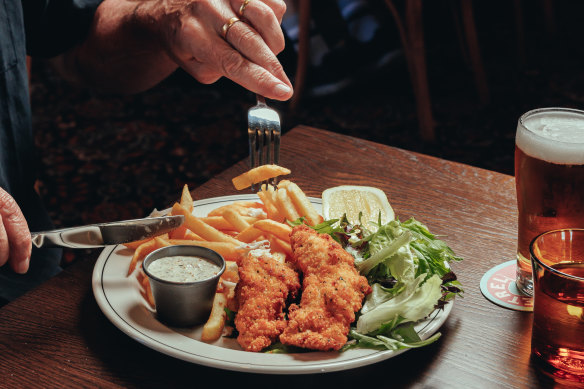 Crumbed snapper with chips, leaves and tartare sauce.