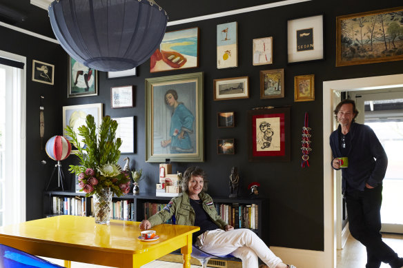 “We consider ourselves lucky to have access to amazing art,” says Moya Delany, in the dining room with husband Jason Buesst. The chairs are by Philippe Starck and the light is by Delany.