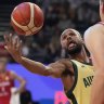 Patty Mills battles German centre Johannes Voigtmann.
