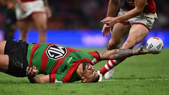 Latrell Mitchell reaches for the ball against the Dolphins.