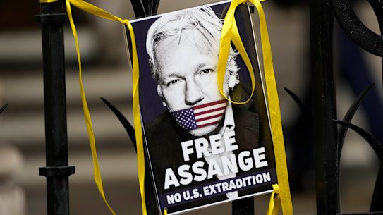 A poster of Julian Assange is attached to the gate at the entrance the High Court in London on Wednesday.