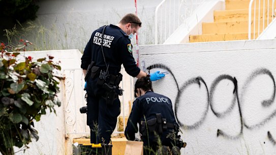 Forensic police examine damage to a property in Maroubra.