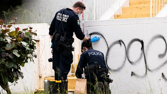 Forensic police examine damage to a property in Maroubra. 
