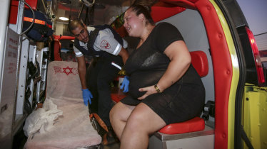 An injured person is treated after a missile from Gaza Strip hit the town of Sderot.