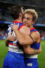 Mitch Wallis celebrates victory over Essendon with teammate Bailey Williams.