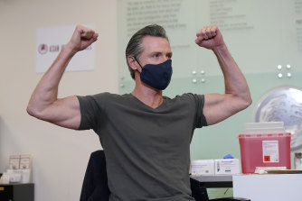 California Governor Gavin Newsom gestures after receiving a Moderna COVID-19 vaccine booster shot in Oakland, California. 