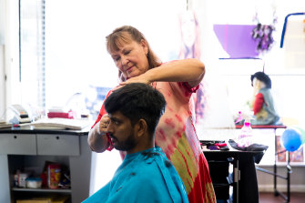 Diane White with a client, Joseph John, in her hairdressing salon in Walgett.