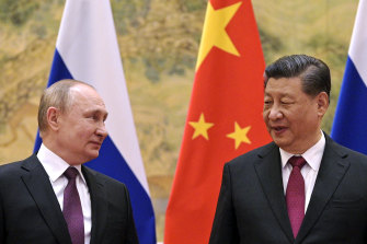 Chinese President Xi Jinping, right, and Russian President Vladimir Putin looks towards each other during their meeting in Beijing in February. While China urges caution, its social media outlets push for outright denial.