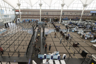 Travellers make their ways to the south security checkpoint in the main terminal of Denver International Airport in Denver.