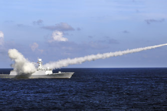A Chinese frigate fires a test missile during military drills in the South China Sea in 2016.