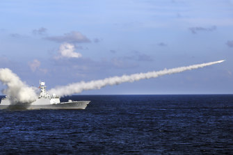 A Chinese frigate fires a test missile during military drills in the South China Sea in 2016.