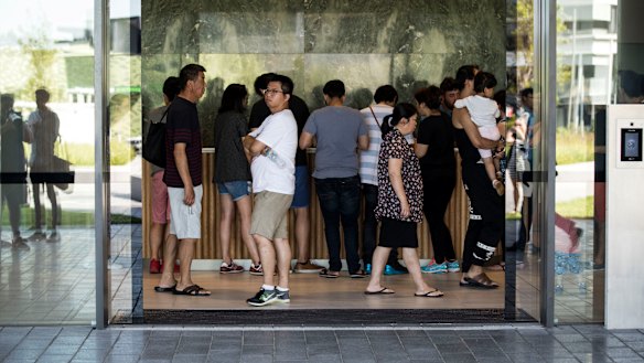 Residents of Opal Tower assemble for an emergency meeting.