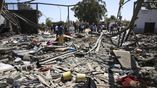 Debris covers the ground after air strikes at a detention centre in Tajoura, east of Tripoli in Libya.