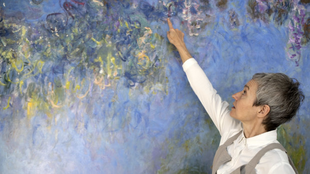Ruth Hoppe, the modern art conservator at the Gemeentemuseum, with a painting of wisteria by Monet in The Hague, May 24, 2019. After Hoppe X-rayed the work, she  found that another painting of water lilies was underneath.  