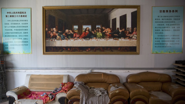 A painting of the Last Supper next to posters quoting China's constitution on religious freedom in a house church shut down by authorities near the city of Nanyang in central China's Henan province. 