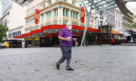 A lone man walks in an otherwise empty Queen Street Mall in Brisbane's CBD on Saturday.