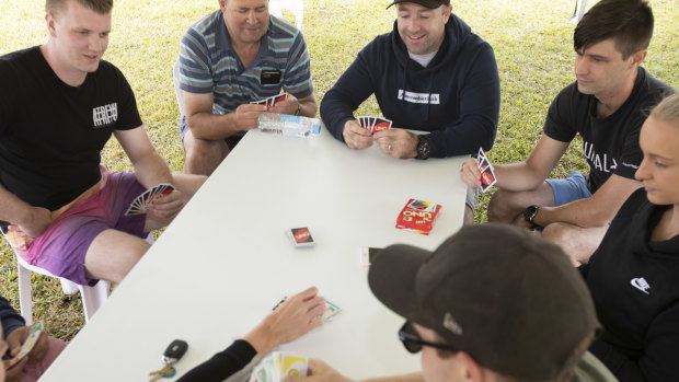 Victorian Police play a game of UNO after shift work on the borders.