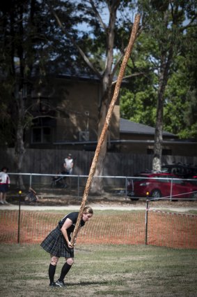 Helen Oakley competes in the caber-tossing competition.