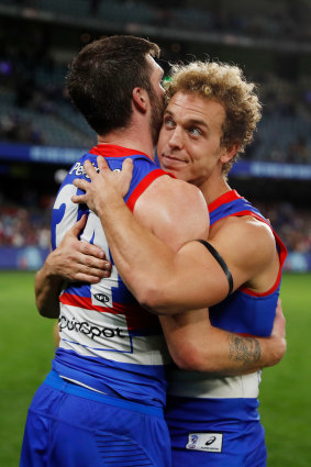 Mitch Wallis celebrates victory over Essendon with teammate Bailey Williams.