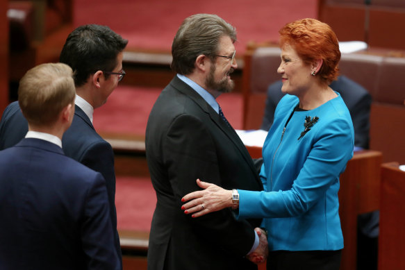 Senator Pauline Hanson is congratulated by Senator Derryn Hinch after delivering her first speech in the Senate, 2016.