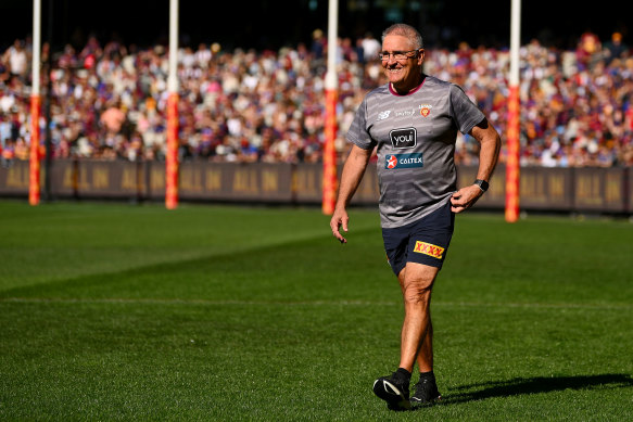 Brisbane Lions coach Chris Fagan soaks up the warmth during the side’s training session at the MCG on Friday.
