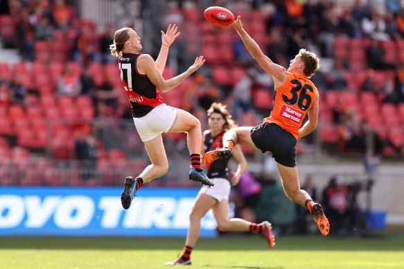 Mason Redman contests the ball with Harry Perryman.