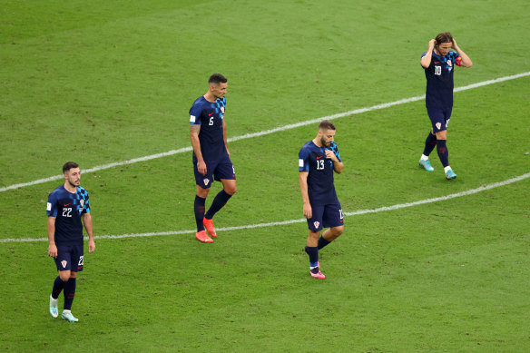 Josip Juranovic, Dejan Lovren, Nikola Vlasic and Luka Modric of Croatia look dejected after Julian Alvarez’s second goal.