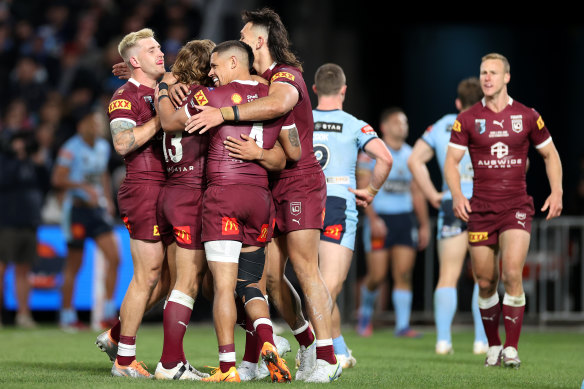 The Maroons celebrate Valentine Holmes’ try.