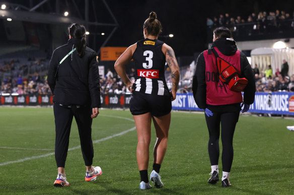 Collingwood captain walks to the rooms to be assessed.