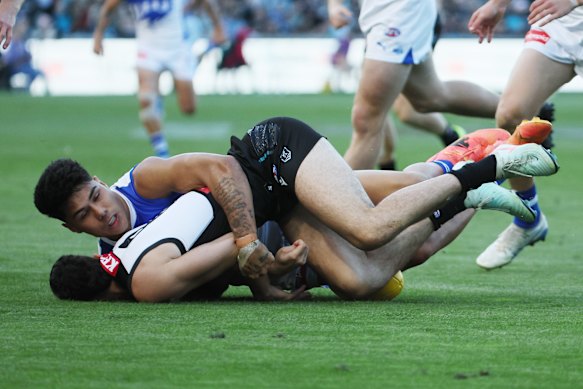 Concussed: Josh Sinn is tackled by Paul Curtis of the Kangaroos.