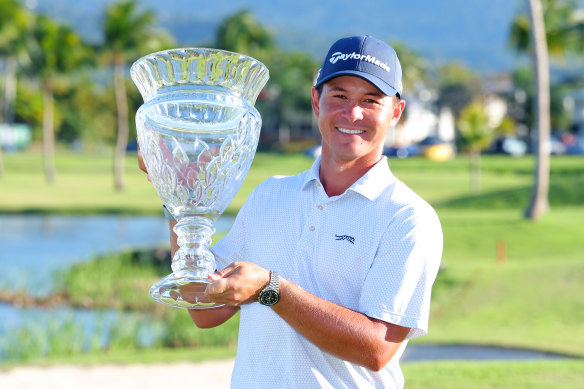 Karl Vilips of Australia poses with the winner’s trophy.