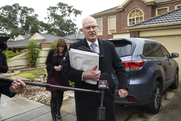 IBAC investigators outside Adem Somyurek's home on Tuesday. 