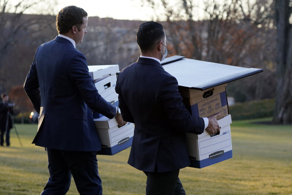 Aides carry boxes to Marine One helicopter on the day Donald Trump left the White House in 2021.