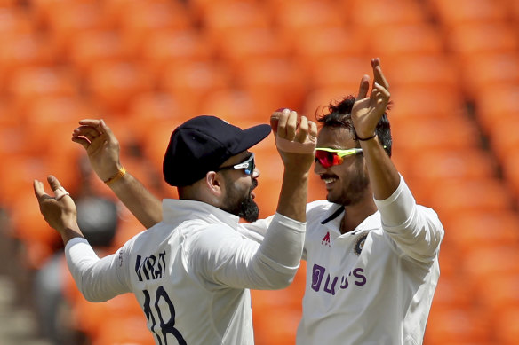 Axar Patel (right) and Virat Kohli celebrate dismissing Ben Stokes in Ahmedabad in 2021.