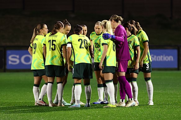 The players huddle before the match. 