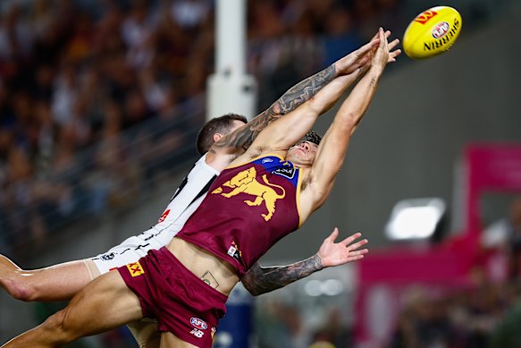 Cam Rayner of the Lions attempts to mark the ball.