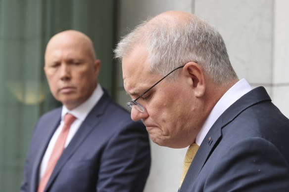 Scott Morrison with Defence Minister Peter Dutton during a press conference on Tuesday, hours before the Prime Minister tested positive to COVID-19.