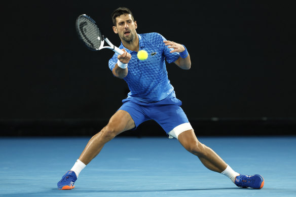 Novak Djokovic, with his leg taped, on his way to beating Frenchman Enzo Couacauo.