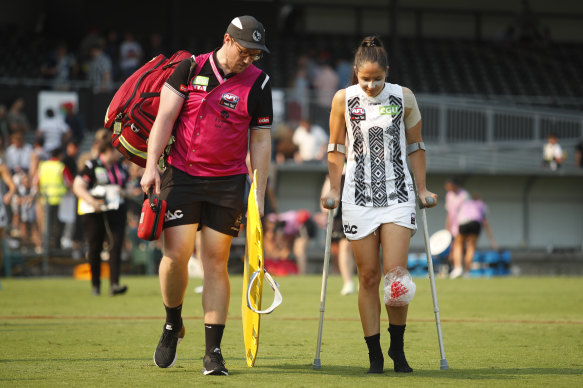 The Magpies’ Jordan Membrey on crutches after injuring her knee against Melbourne on Sunday.