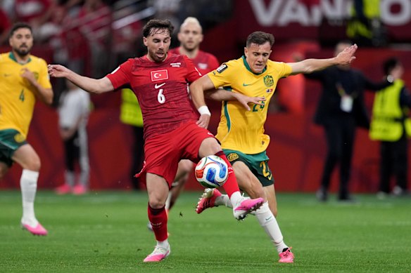 Australia’s Paul Okon-Engstler (24) shows his determination to win the ball off Turkey’s Orkun Kokcu (6).