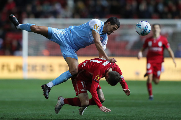 Nuno Miguel Pereira Reis of Melbourne City and Craig Goodwin of United come together.