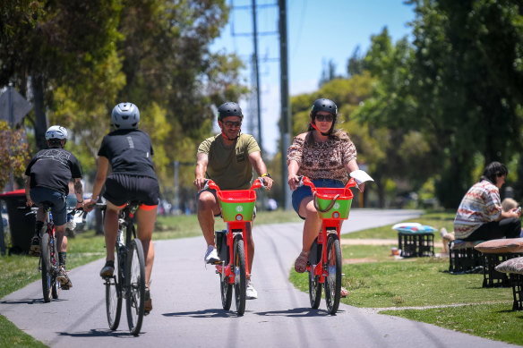 Jeremy Pereira and partner Gianna Donnini give the Lime bikes a go in Brunswick on Tuesday.
