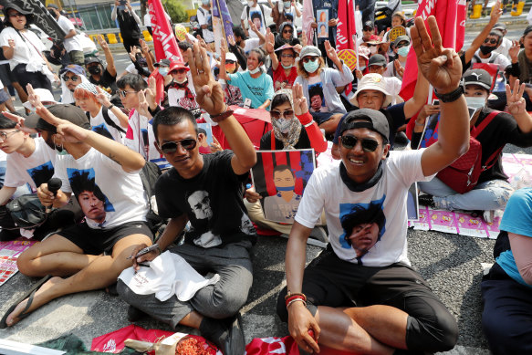Pro-democracy activists gesture with a three-fingers salute, a symbol of resistance, as they arrive at the Attorney-General’s office in Bangkok, in March.