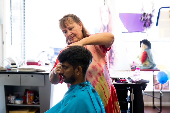 Diane White with a client, Joseph John, in her hairdressing salon in Walgett.