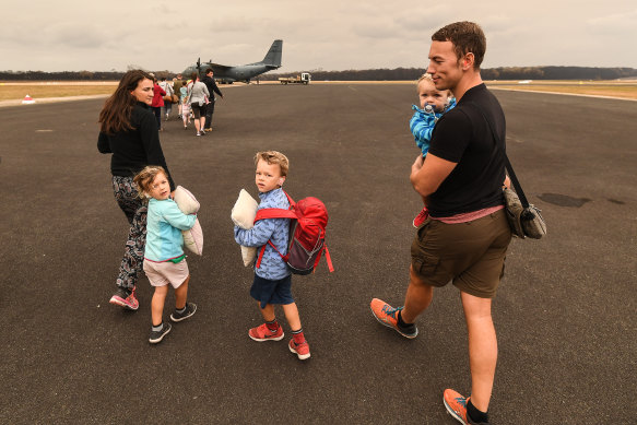 Kai Kirschbaum and wife Deniz with Samira, Kian and Nuri about to board their flight out of Mallacoota on January 5.